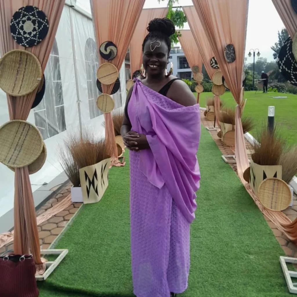 Beverley in purple and black outfit.