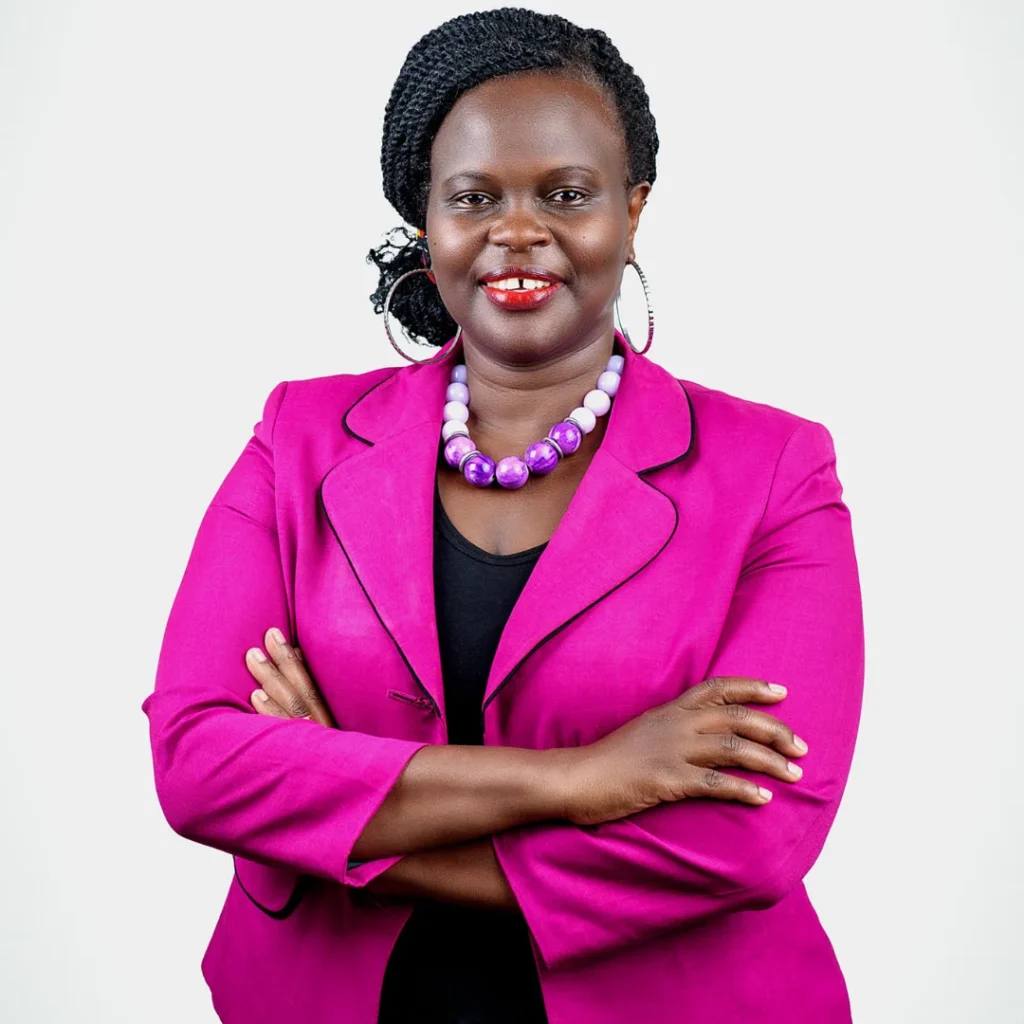 Beverley in a purple blazer and black top.