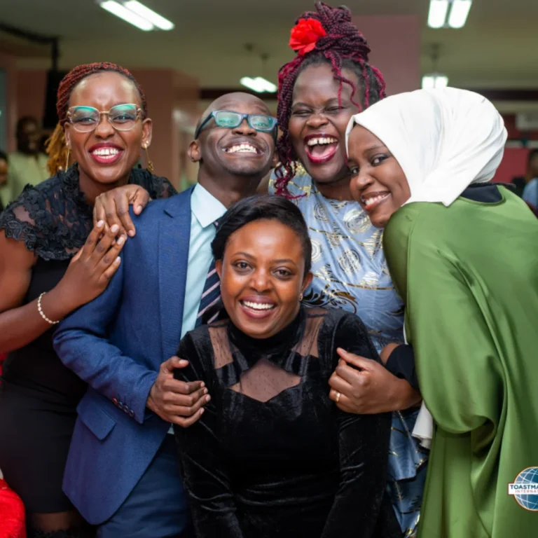 Group of 5 people smiling at the camera.