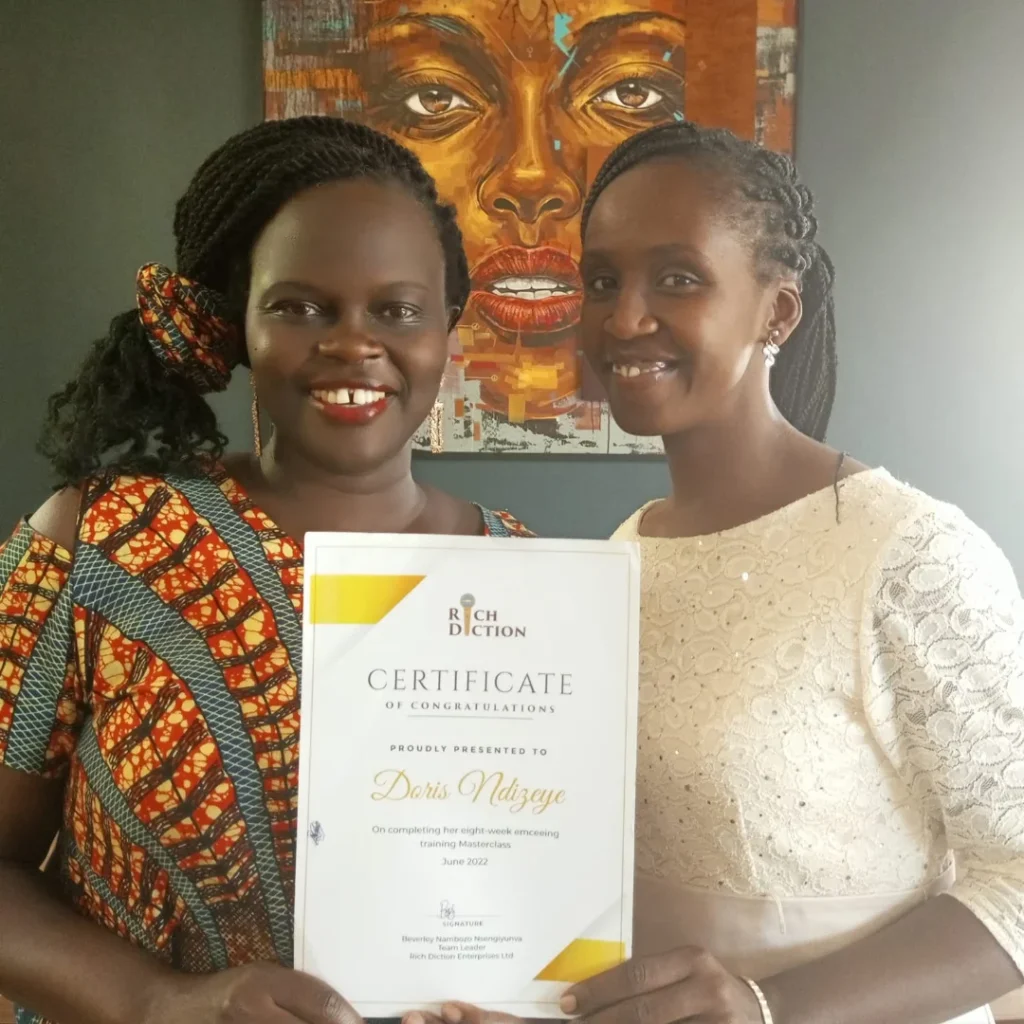 Beverley holding a certificate with one of her individual coaching students.